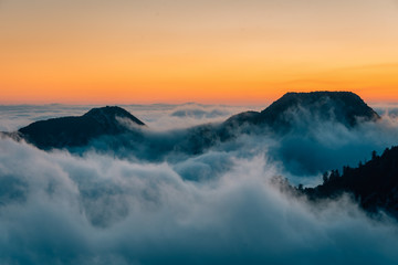 Fototapeta na wymiar View of marine layer low clouds over Los Angeles at sunset, from Mount Wilson, in Angeles National Forest, California