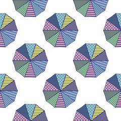 Parasols from above with geometric designs in a summery color scheme.