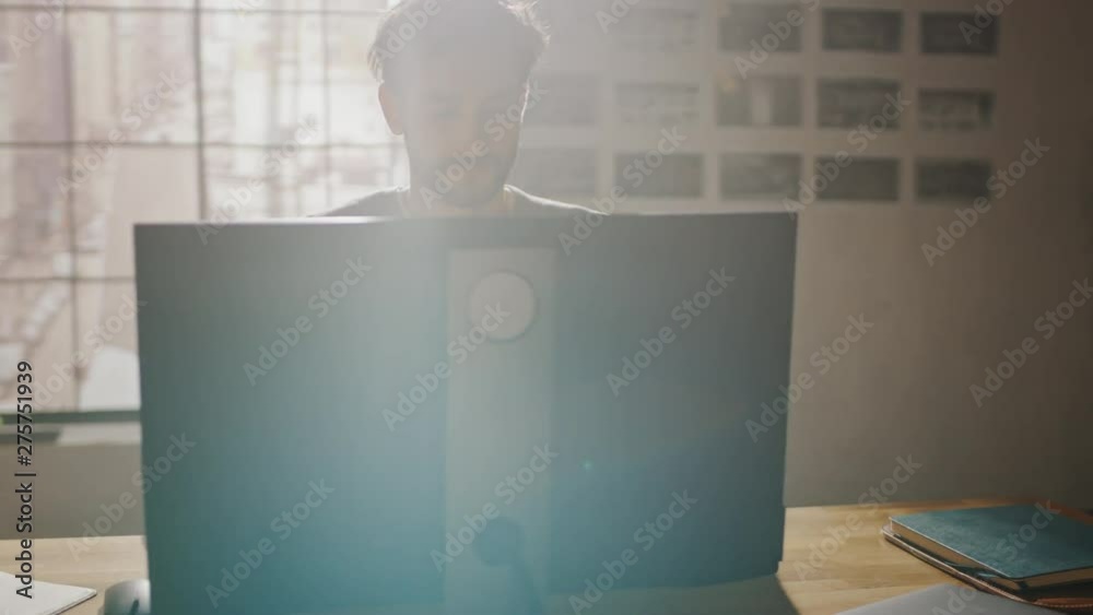 Aufkleber Creative Designer Sitting at His Desk in Office Studio Working on a Desktop Computer with Smartphone Software Development Application on Screen. Web, App Developer. 360 Degree Tracking Arc Shot