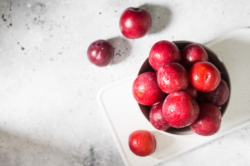 Red plum. Light background. Healthy diet