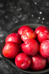 Red plum. Dark background. Healthy diet