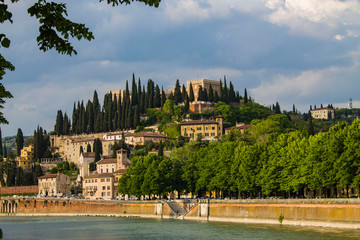 Fototapeta na wymiar Cityscape embankment view, Verona, Italy. Sunny day. Adige river that crosses Verona. 
