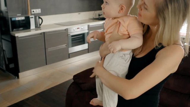 Mother and her baby son spanding time at home together.