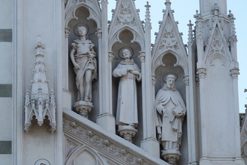 Statues of St. Victor, Francis of Assisi and Nicholas of Tolentino on the facade of Sacro Cuore del Suffragio church in Rome, Italy  
