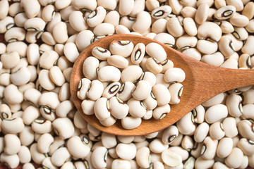 Black eyed beans in wooden  spoon.