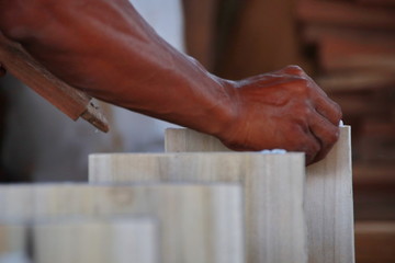 Carpenters work on woodworking machinery in carpentry shops