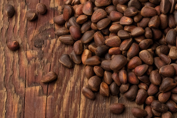 inshell pine nuts on a wooden background. View top. Copy space