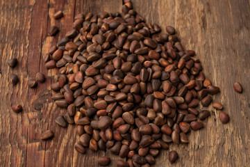inshell pine nuts on a wooden background. Top view