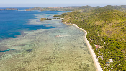 Seacoast with coral reef and white beach.Lagoon with coral reef and clear water, top view.aerial view