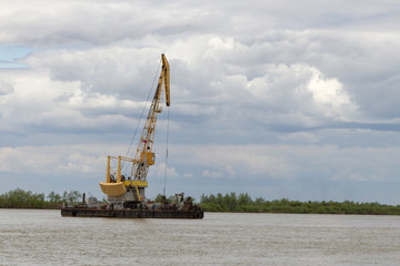 Floating crane on the river