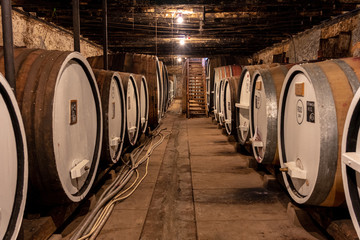 Old wine barrels in a cellar on a winery Tour in Victoria, Australia