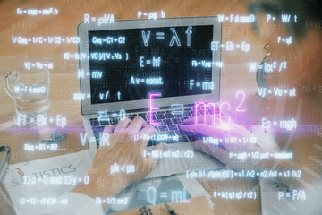 Science formula hologram with man working on computer on background. Education concept. Double...