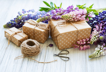 Obraz na płótnie Canvas Lupine flowers and gift boxes