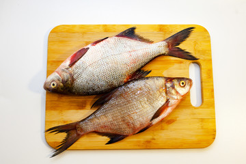 River fish bream on the cutting Board. White background
