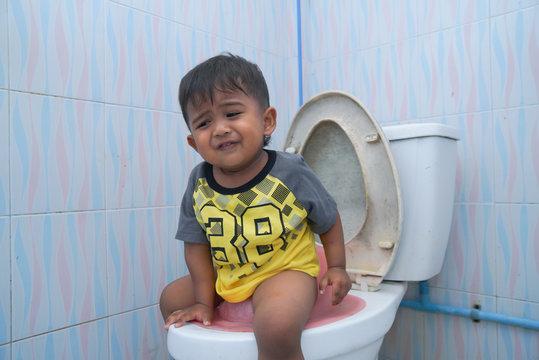 Cute Little Asian Boy Sitting On The Toilet,Baby Constipation Concept