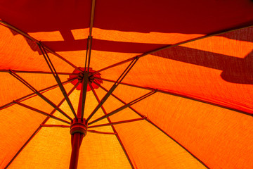 Close-up the structure of the orange beach umbrella made of wooden for protected sunlight.
