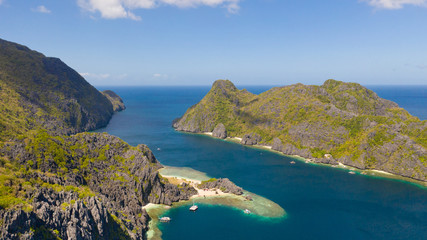 Seascape with tropical islands. El Nido Palawan National Park Philippines. Rocky islands covered with forest. Small lagoons with white beaches. Boat tours between the islands.