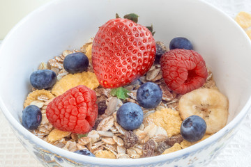 Healthy breakfast with ripe berries in a bowl of muesli