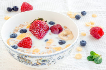 Milk with muesli and berries for breakfast