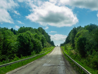 road against the blue sky with clouds