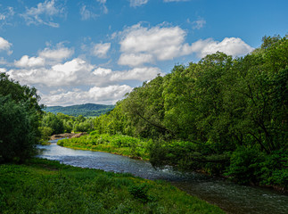 Aerial view of the mountain river flowing in the valley
