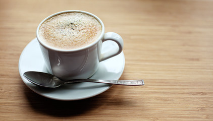 Cup of coffee on wooden desk breakfast in the morning