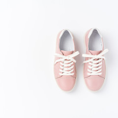 Pink sneakers on white background. Top view