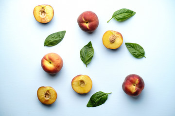 Creative summertime fruit layout made of sweet ripe peaches on blue background. Healthy food, delicious dessert