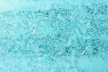 Frost on glass in winter. Pattern snow and ice on window
