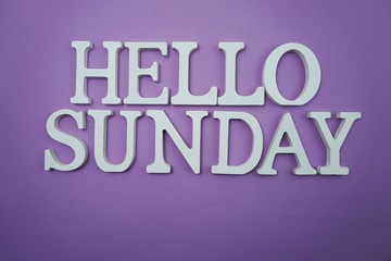Hello Sunday wooden letter alphabet on purple background