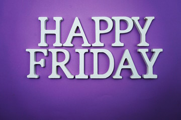 Happy Friday wooden letter alphabet on purple background