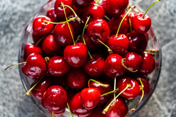 Cherries in bowl on stone table