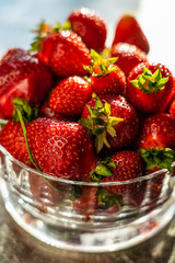 Strawberries in bowl on stone table