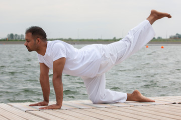 Fototapeta na wymiar Young man doing yoga in morning park.man relax in nature
