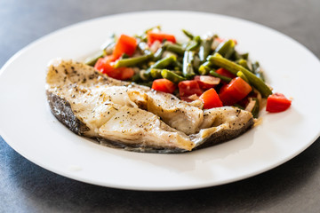 Fish dish - fish fillet in sauce and vegetables