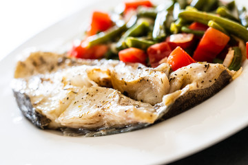 Fish dish - fish fillet in sauce and vegetables