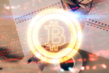 Cryptocurrency hologram over woman's hands writing background. Concept of blockchain. Double...
