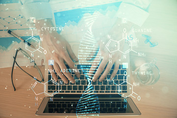 DNA hologram with businessman working on computer on background. Concept of bioengineering. Double exposure.