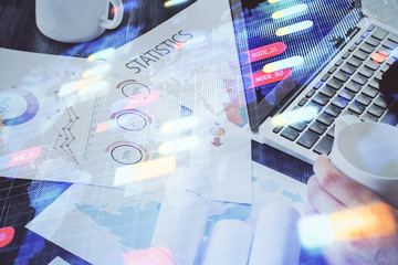 Multi exposure of technology hologram with man working on computer background. Concept of big data.