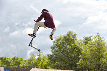 Teen rides on an extreme scooter © aleksandrbs