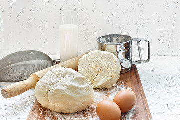 Kneading dough. Cooking dough. Dough on a wooden board with a rolling pin.