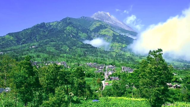 Scenic mount Merapi volcano in Indonesia on a beautiful sunny day. Footage fades out to white at the end.