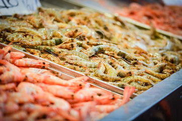 fresh seafood within the fish market in Spain - octopus, shells, shrimps, fish, oysters, lobster 