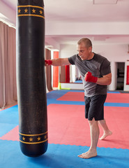 Muay thai fighter with heavy bag