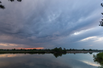 Unusually beautiful sky over the river. Unusual landscape in cloudy weather.