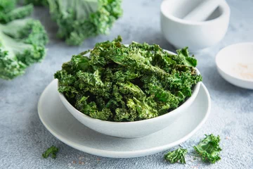 Poster crispy kale chips in bowl, healthy vegan food © anna_shepulova
