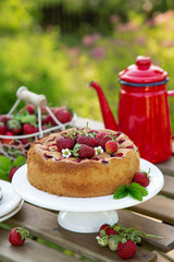 cake with fresh strawberry on wooden table, outdoor