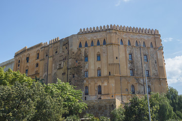 Facade of historical royal palace in Palermo Sicily, view of the garden and old architecture of Norman palace 