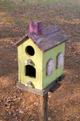 Wooden bird house in the forest.