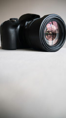 Black digital camera isolated on a light background